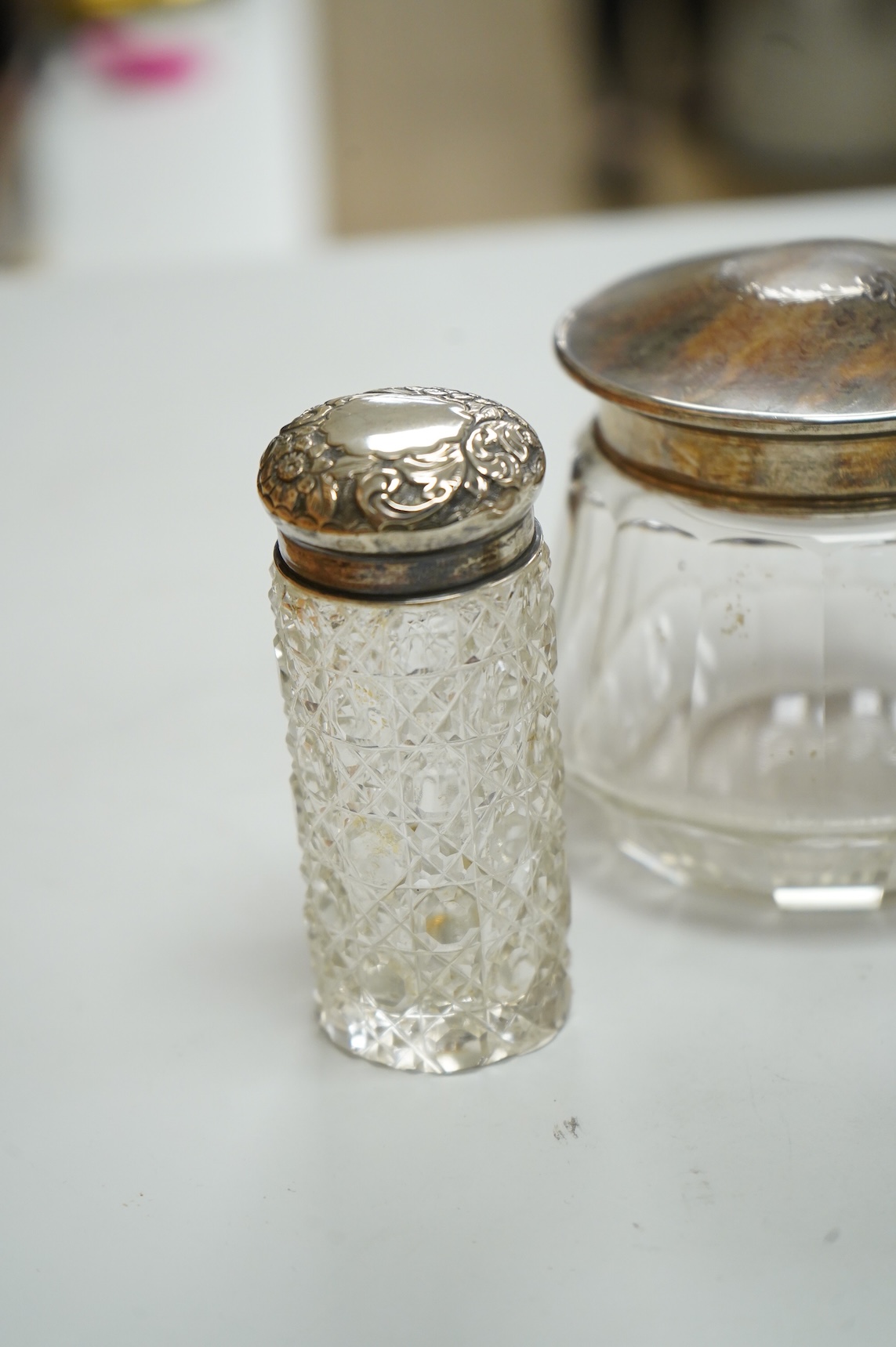 Three George V silver and tortoiseshell mounted glass toilet jars, Adie Brothers, Birmingham, 1925 & 1927, together with three other silver mounted glass toilet jars.